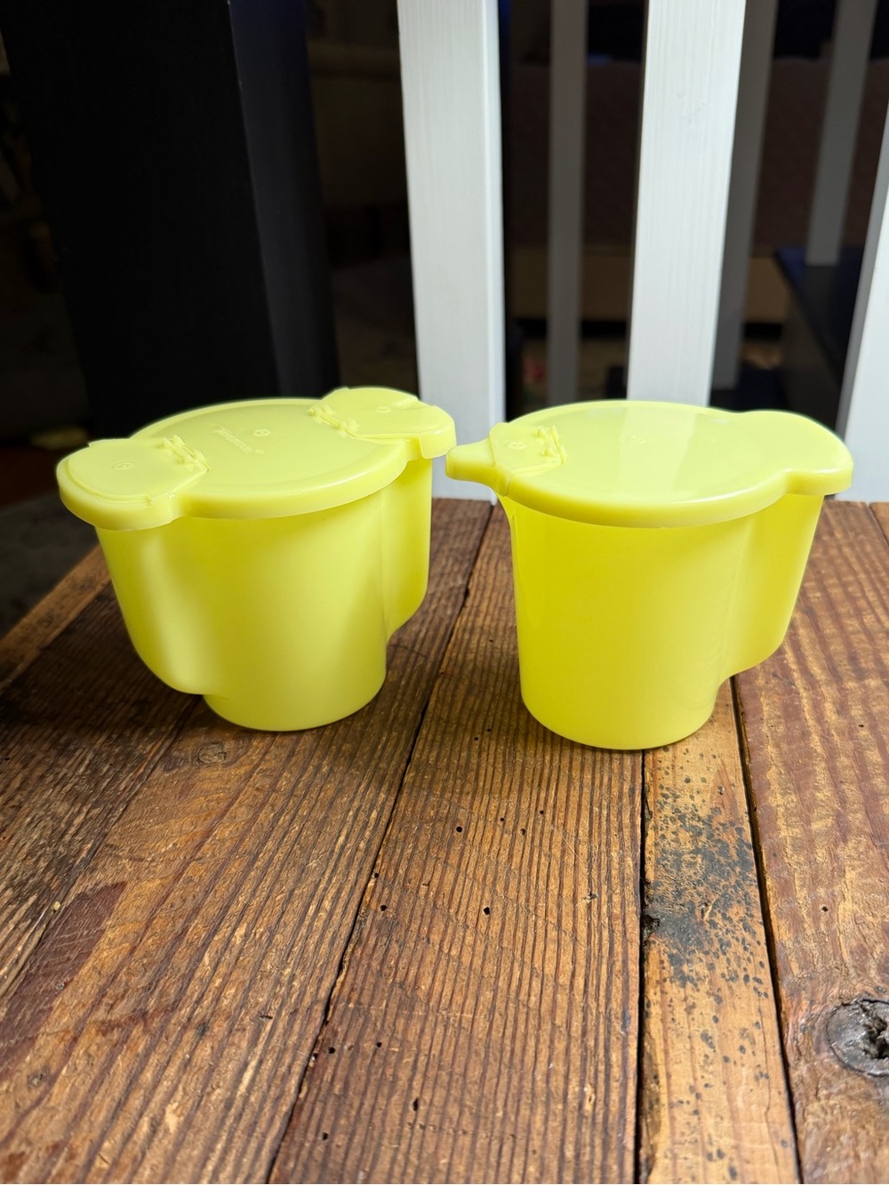 Set of vintage yellow Tupperware flip-top cream and sugar dispensers